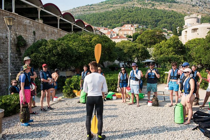 Dubrovnik: Sunset Kayak & Snorkel Tour with Wine & Water - Returning beneath the Old Town